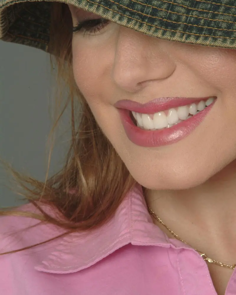 Close-up of a woman with a beautiful, confident smile showcasing her perfect porcelain veneers from Smile Design NJ