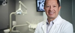 Dr Aristo Carranza, a Digital Smile Design Master dentist in Westfield NJ, standing in his modern clinic.